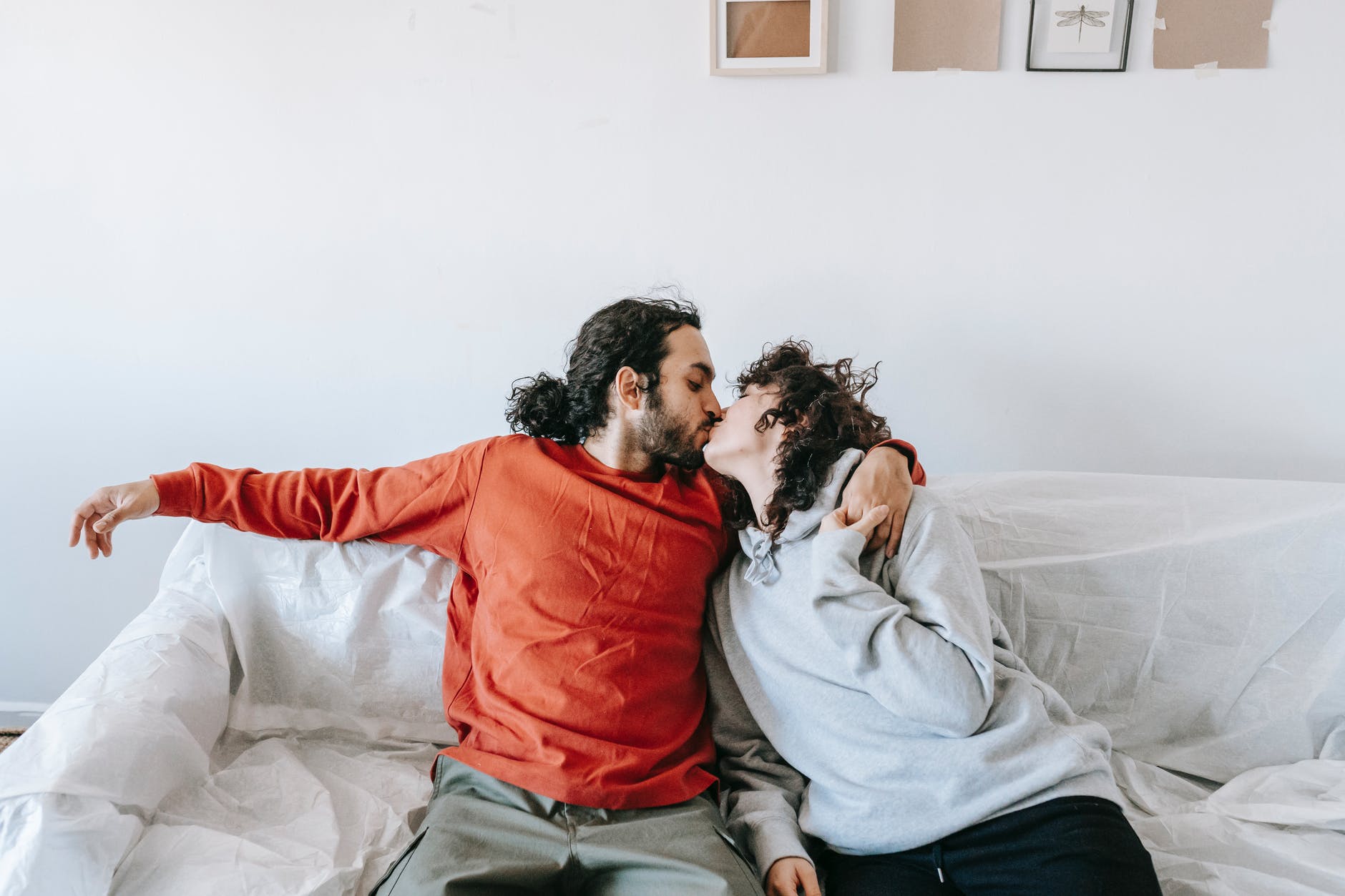 couple sitting on a couch and kissing
