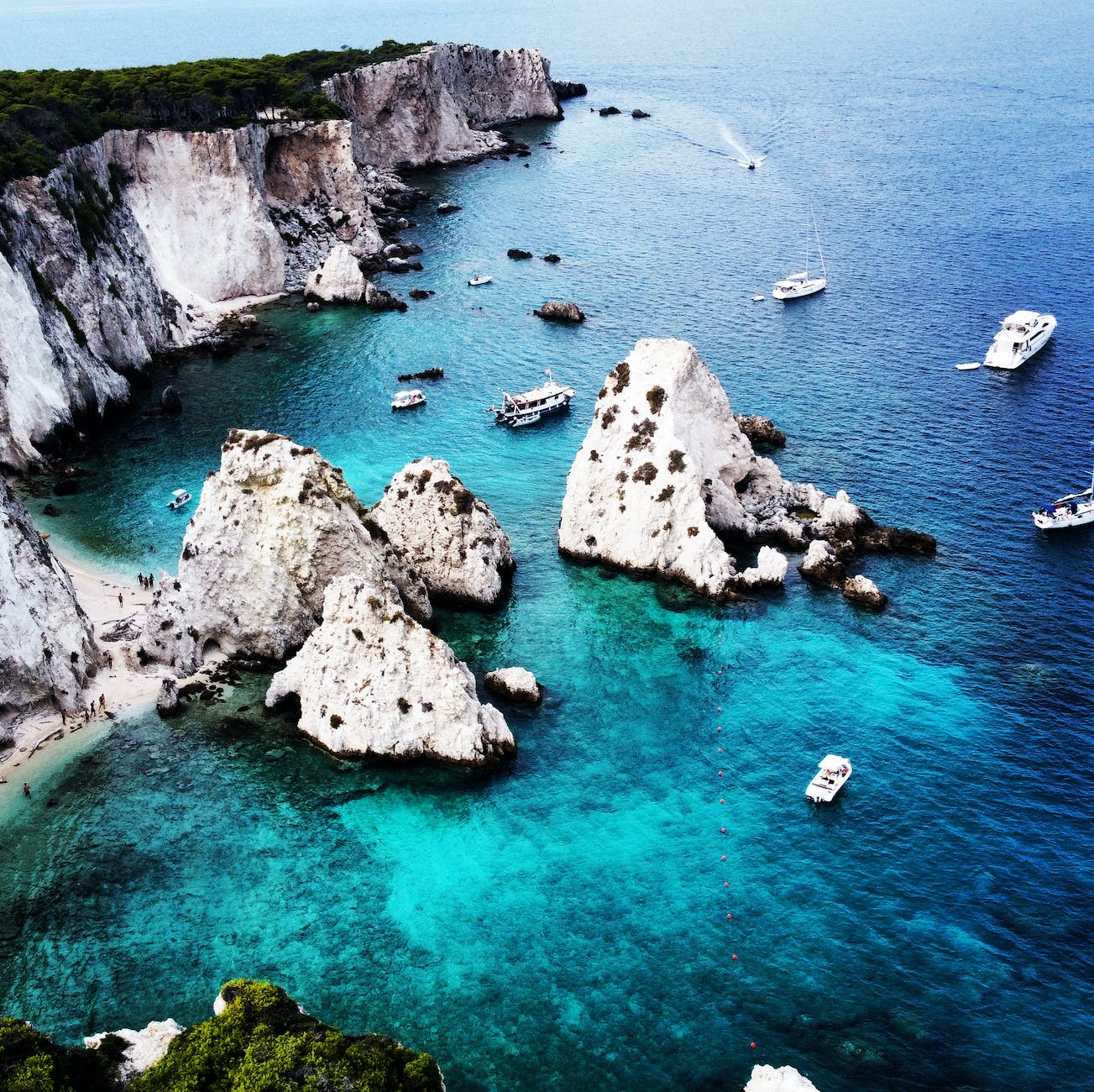 white and gray rock formation on body of water
