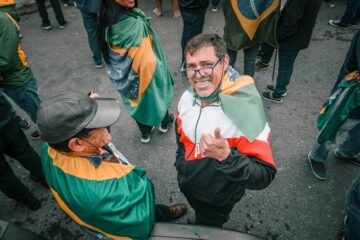 happy man on a parade with a brazilian flag